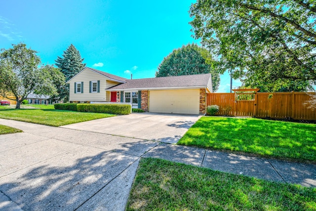 1138 Edgebrook Ave, New Carlisle, OH 45344 - tri-level home with an attached garage, driveway, brick siding, and a gate