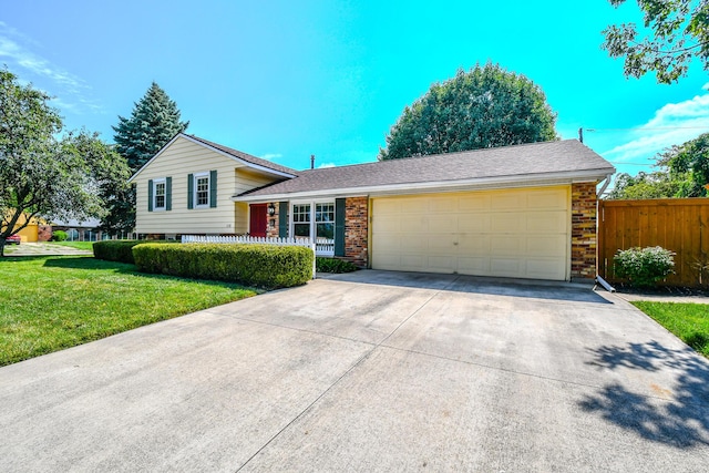 1138 Edgebrook Ave, New Carlisle, OH 45344 - tri-level home with an attached garage, concrete driveway, and brick siding