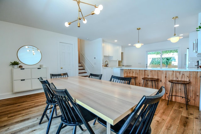 1138 Edgebrook Ave, New Carlisle, OH 45344 - dining area featuring light wood-style floors, stairway, a chandelier, and recessed lighting