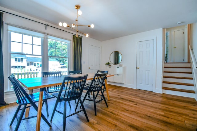 1138 Edgebrook Ave, New Carlisle, OH 45344 - dining space with a chandelier, wood-type flooring, and stairs
