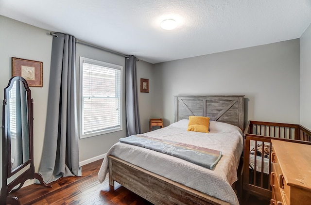 bedroom with dark wood-style floors and baseboards