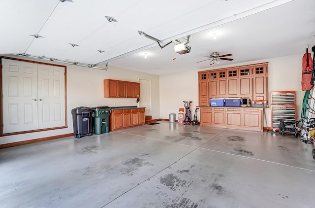 garage featuring a garage door opener and baseboards