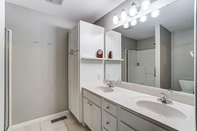 full bathroom with a stall shower, a sink, visible vents, and tile patterned floors