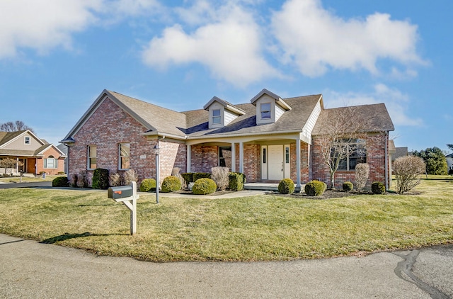 view of front of property featuring a front lawn and brick siding