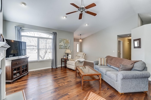 living area featuring visible vents, baseboards, lofted ceiling, ceiling fan, and wood finished floors