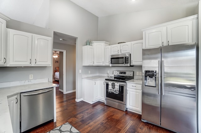 kitchen with dark wood-style floors, white cabinetry, appliances with stainless steel finishes, and light countertops