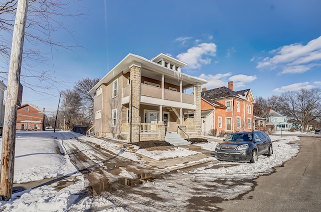 view of front of home with a porch, a residential view, and a balcony