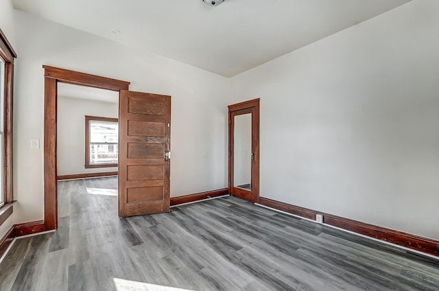 empty room with wood finished floors and baseboards