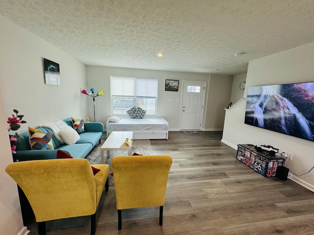 1556 Knights Way, Sidney, OH 45365 - living room featuring a textured ceiling, baseboards, and wood finished floors