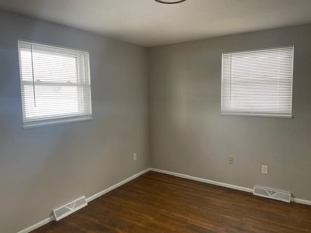 unfurnished room featuring dark hardwood / wood-style floors