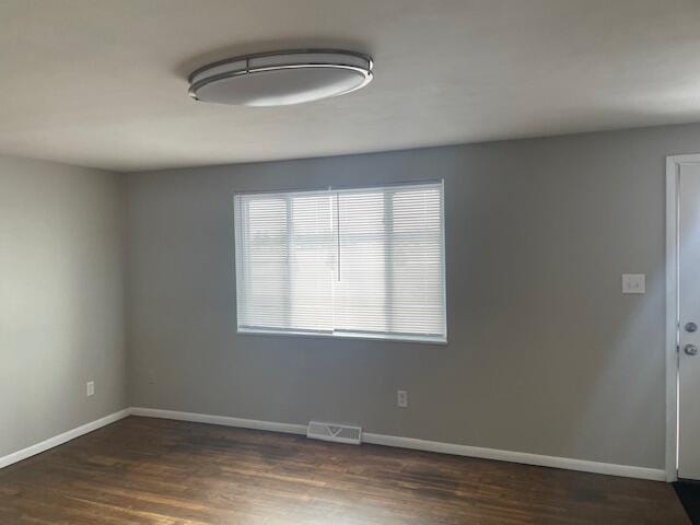 unfurnished room with dark hardwood / wood-style floors