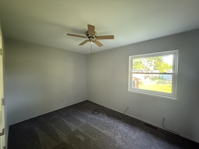 118 S Troy St, Bellefontaine, OH 43311 - unfurnished room with ceiling fan and dark carpet