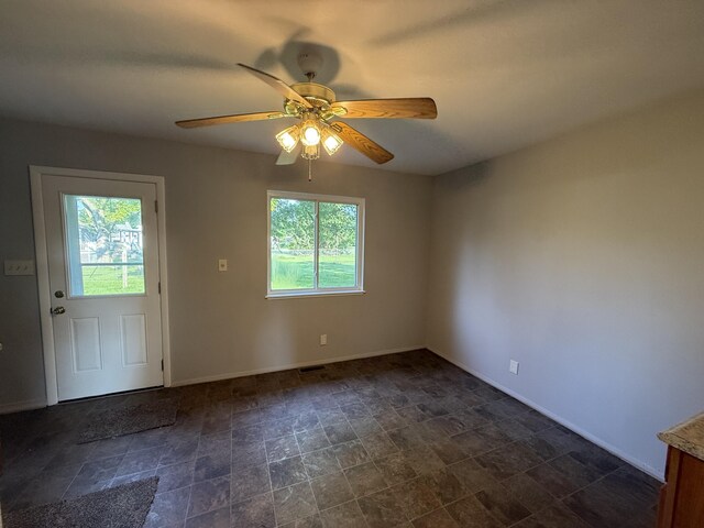 118 S Troy St, Bellefontaine, OH 43311 - spare room with healthy amount of natural light, stone finish flooring, and a ceiling fan