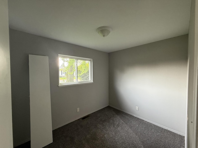 118 S Troy St, Bellefontaine, OH 43311 - unfurnished room featuring dark colored carpet and baseboards