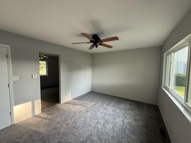 118 S Troy St, Bellefontaine, OH 43311 - unfurnished room with dark carpet, healthy amount of natural light, and ceiling fan