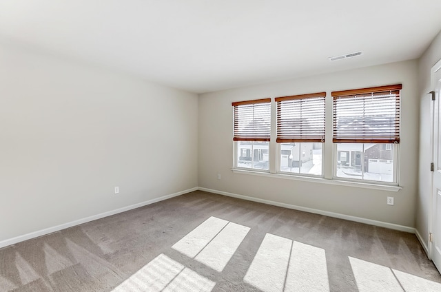 spare room with light colored carpet