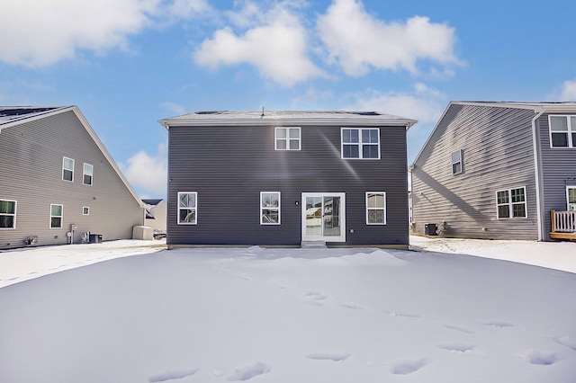 view of snow covered rear of property