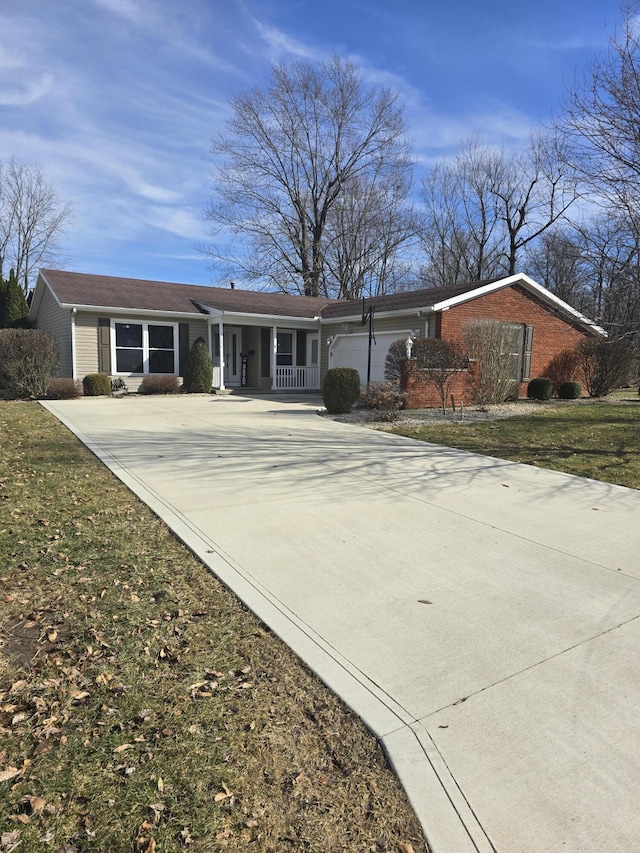 ranch-style house with driveway, a porch, a front lawn, and an attached garage