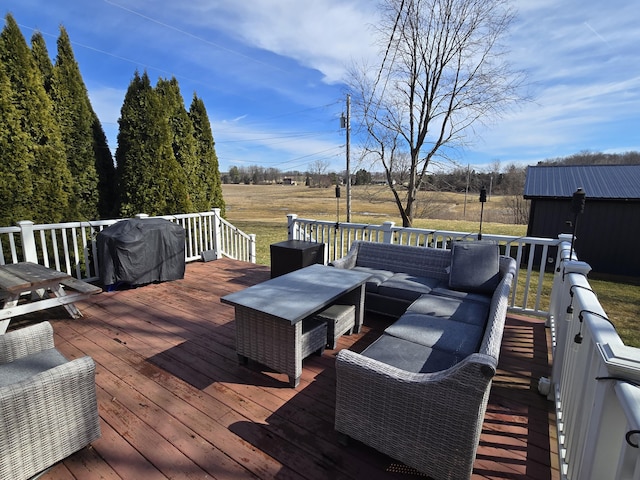 wooden terrace with area for grilling and an outdoor hangout area