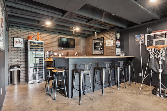 3600 Magnolia Trace Dr, Bellbrook, OH 45305 - indoor wet bar featuring brick wall and concrete flooring