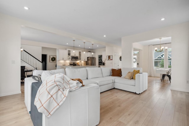 3600 Magnolia Trace Dr, Bellbrook, OH 45305 - living room with stairs, a chandelier, light wood finished floors, recessed lighting, and baseboards