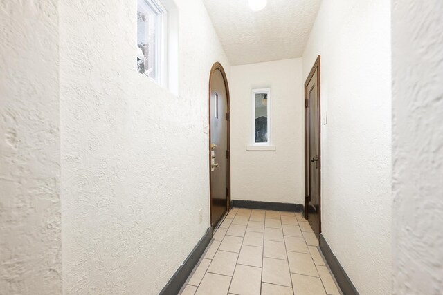 651 Eastern Ave, Bellefontaine, OH 43311 - hallway featuring a textured ceiling, a textured wall, and light tile patterned floors