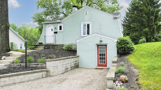 651 Eastern Ave, Bellefontaine, OH 43311 - view of front facade with stucco siding and a chimney