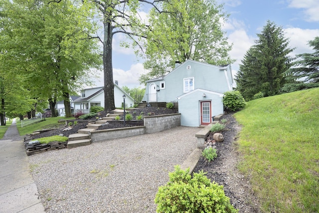 651 Eastern Ave, Bellefontaine, OH 43311 - view of side of home with stucco siding and a yard