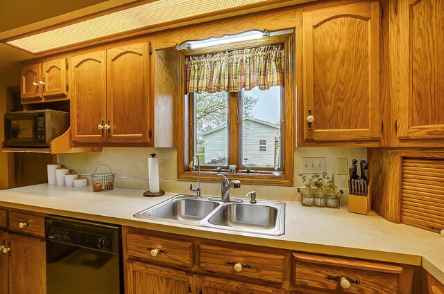 426 School St, Bradford, OH 45308 - kitchen with light countertops, backsplash, black appliances, brown cabinets, and a sink