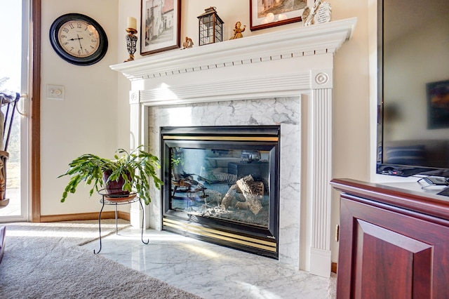 details featuring baseboards and a high end fireplace