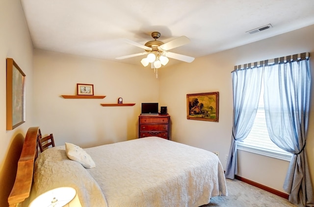 bedroom with a ceiling fan, light colored carpet, visible vents, and baseboards