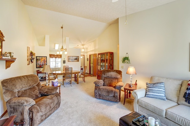 living room featuring carpet floors, high vaulted ceiling, and an inviting chandelier