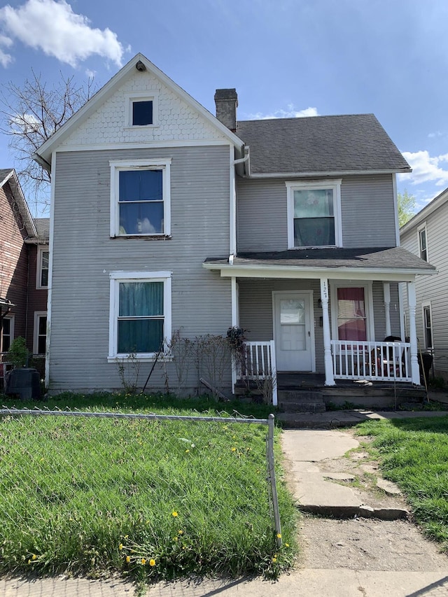 127 Rice St, Springfield, OH 45505 - traditional-style home featuring a front yard, covered porch, and a chimney