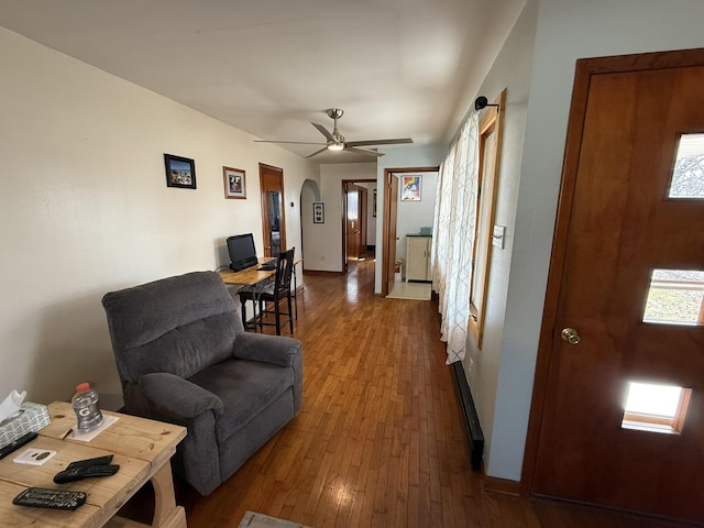 living room featuring dark hardwood / wood-style floors and ceiling fan