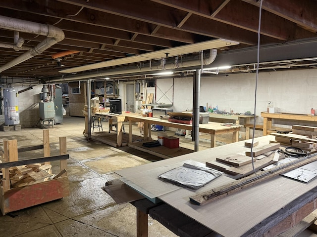 basement featuring water heater and a workshop area