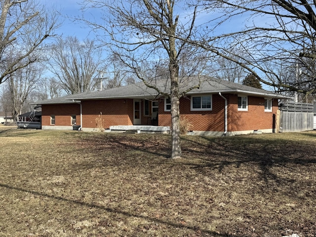 back of property with a lawn