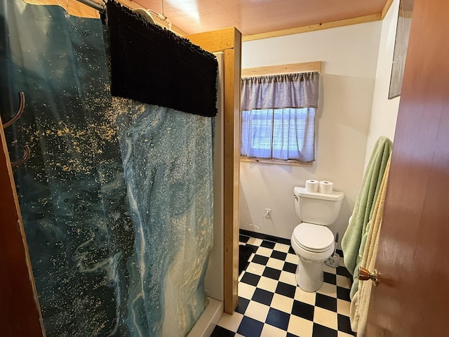 bathroom with toilet and a shower with shower curtain