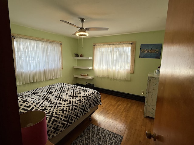 bedroom with ceiling fan and hardwood / wood-style floors