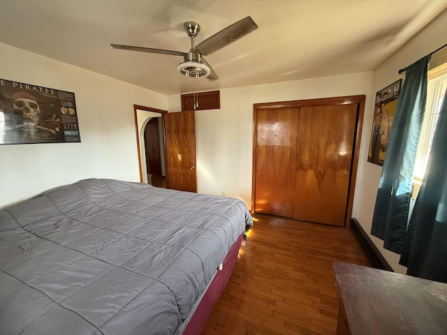 bedroom with wood-type flooring, a closet, and ceiling fan