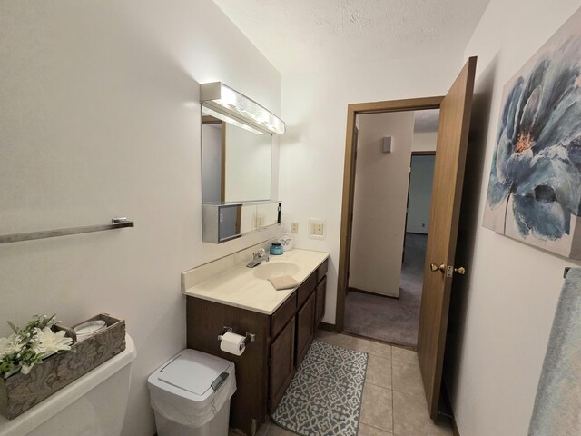 3032 Armsgate Rd Unit 25, Springfield, OH 45503 - bathroom featuring vanity, tile patterned flooring, and a textured ceiling