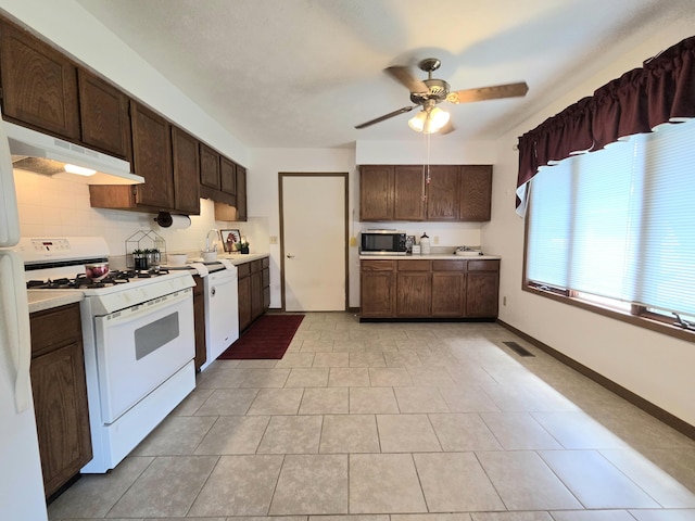 3032 Armsgate Rd Unit 25, Springfield, OH 45503 - kitchen with white appliances, under cabinet range hood, dark brown cabinetry, ceiling fan, and light countertops