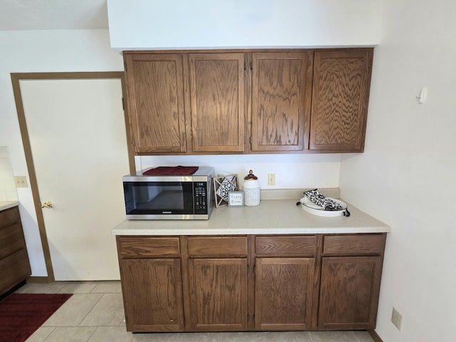 3032 Armsgate Rd Unit 25, Springfield, OH 45503 - kitchen with stainless steel microwave, light countertops, and light tile patterned floors
