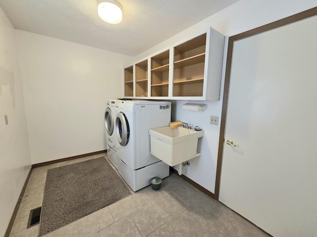 3032 Armsgate Rd Unit 25, Springfield, OH 45503 - laundry room with washer and clothes dryer and light tile patterned floors
