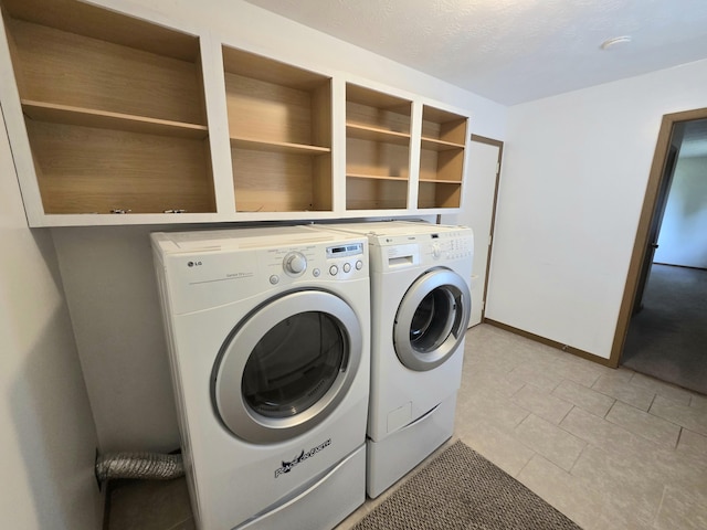 3032 Armsgate Rd Unit 25, Springfield, OH 45503 - laundry room with washer and clothes dryer and light tile patterned flooring