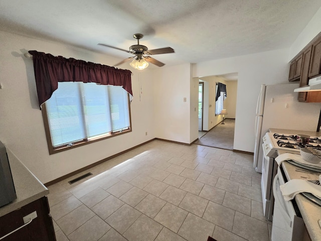 3032 Armsgate Rd Unit 25, Springfield, OH 45503 - kitchen featuring gas range gas stove, ceiling fan, light tile patterned floors, and under cabinet range hood