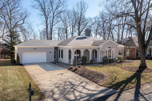 ranch-style house with a garage and a front lawn