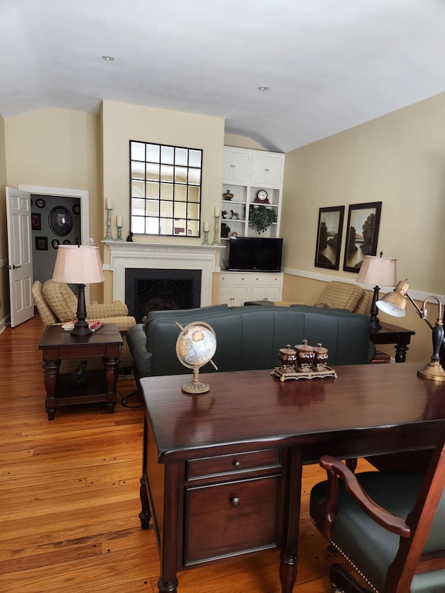 interior space featuring hardwood / wood-style flooring and vaulted ceiling