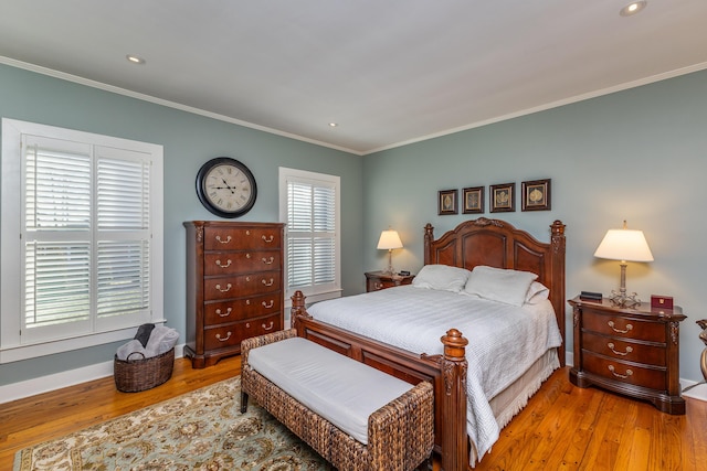 bedroom with light hardwood / wood-style flooring and crown molding