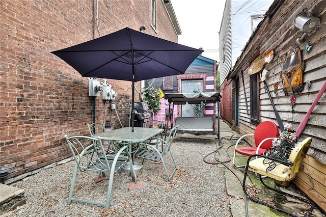 view of patio featuring area for grilling and outdoor dining area