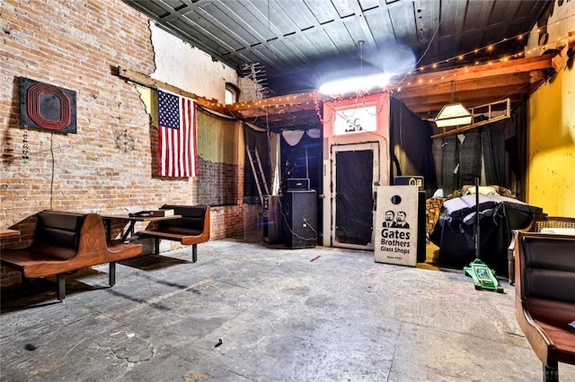 misc room with brick wall and heating unit